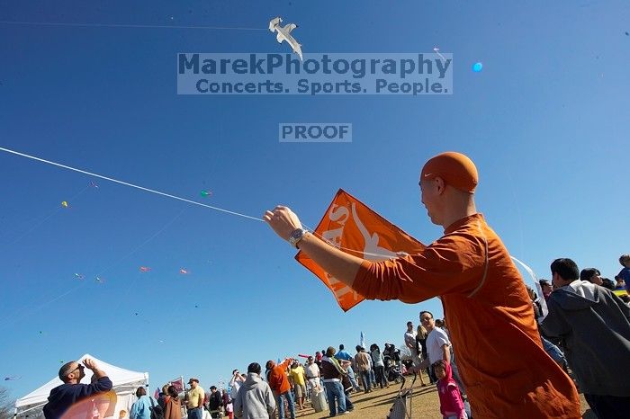 Chris Lam attempts to fly his UT kite at the 79th annual Zilker Park Kite Festival, Sunday, March 4, 2007.

Filename: SRM_20070304_1531541.jpg
Aperture: f/11.0
Shutter Speed: 1/250
Body: Canon EOS-1D Mark II
Lens: Sigma 15-30mm f/3.5-4.5 EX Aspherical DG DF