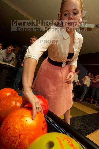 Carol Gossett reaching for a bowling ball.  Alpha Xi Delta held a sock hop themed date night at the Austin 300 bowling alley, Thursday night, March 29, 2007.

Filename: SRM_20070329_2036381.jpg
Aperture: f/8.0
Shutter Speed: 1/200
Body: Canon EOS-1D Mark II
Lens: Sigma 15-30mm f/3.5-4.5 EX Aspherical DG DF