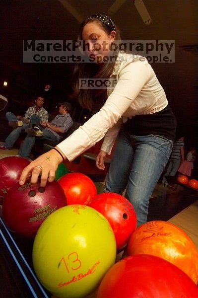 Allison Lear reaching for a bowling ball.  Alpha Xi Delta held a sock hop themed date night at the Austin 300 bowling alley, Thursday night, March 29, 2007.

Filename: SRM_20070329_2050141.jpg
Aperture: f/8.0
Shutter Speed: 1/200
Body: Canon EOS-1D Mark II
Lens: Sigma 15-30mm f/3.5-4.5 EX Aspherical DG DF