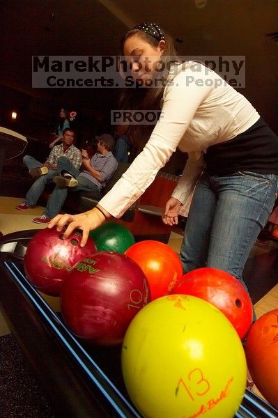 Allison Lear reaching for a bowling ball.  Alpha Xi Delta held a sock hop themed date night at the Austin 300 bowling alley, Thursday night, March 29, 2007.

Filename: SRM_20070329_2050202.jpg
Aperture: f/8.0
Shutter Speed: 1/200
Body: Canon EOS-1D Mark II
Lens: Sigma 15-30mm f/3.5-4.5 EX Aspherical DG DF