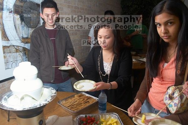 Lance Shyr, left, and Michelle Hoang enjoying the white chocolate.  The Asian Business Students Association (ABSA) hosted a chocolate fondue Friday, January 26, 2007 before heading off to a movie premier.

Filename: SRM_20070126_1624509.jpg
Aperture: f/5.0
Shutter Speed: 1/125
Body: Canon EOS 20D
Lens: Canon EF-S 18-55mm f/3.5-5.6