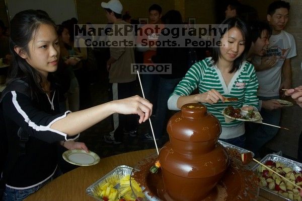 Monica Nguyen and Jacqueline So.  The Asian Business Students Association (ABSA) hosted a chocolate fondue Friday, January 26, 2007 before heading off to a movie premier.

Filename: SRM_20070126_1659444.jpg
Aperture: f/5.6
Shutter Speed: 1/160
Body: Canon EOS 20D
Lens: Canon EF-S 18-55mm f/3.5-5.6