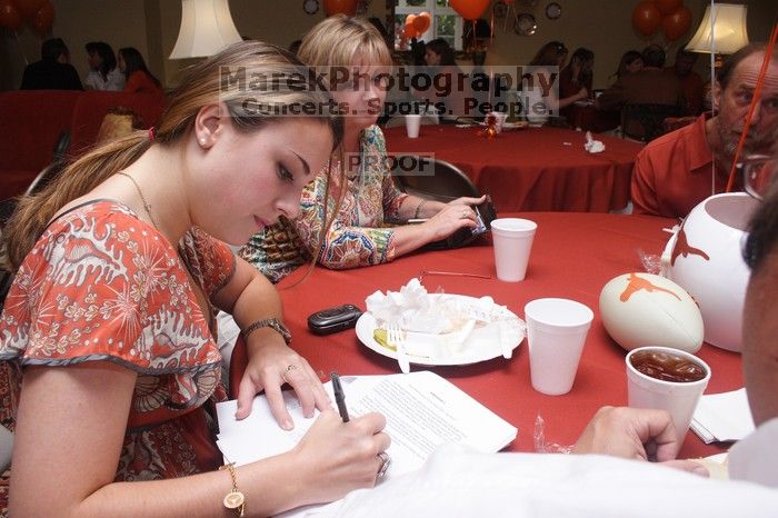 Haley Lyons and her parents sign the Kappa house leasing contract.  Kappa Kappa Gamma (KKG) hosted a parents' weekend barbecue before the UT vs Nebraska football game on Saturday, October 27, 2007 at their sorority house.

Filename: SRM_20071027_1206187.jpg
Aperture: f/8.0
Shutter Speed: 1/250
Body: Canon EOS 20D
Lens: Canon EF-S 18-55mm f/3.5-5.6