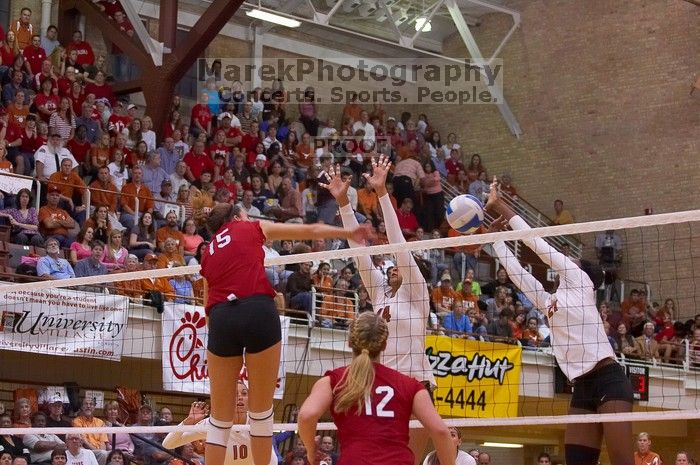 UT senior Brandy Magee (#44, MB) and UT sophomore Destinee Hooker (#21, OH) attempt to block a spike from Nebraska sophomore Kori Cooper (#15, MB) as Nebraska sophomore Rachel Holloway (#12, S) watches.  The Longhorns defeated the Huskers 3-0 on Wednesday

Filename: SRM_20071024_1910128.jpg
Aperture: f/4.0
Shutter Speed: 1/400
Body: Canon EOS-1D Mark II
Lens: Canon EF 80-200mm f/2.8 L