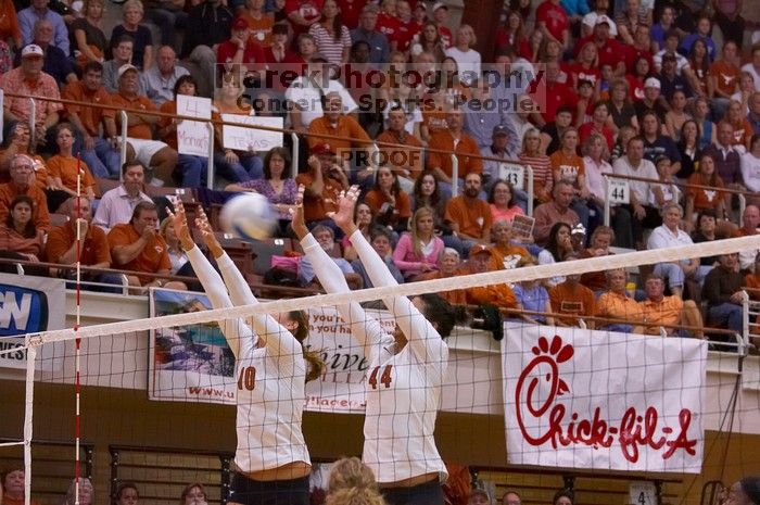 UT sophomore Ashley Engle (#10, S/RS) and UT senior Brandy Magee (#44, MB) attempt to block the ball.  The Longhorns defeated the Huskers 3-0 on Wednesday night, October 24, 2007 at Gregory Gym.

Filename: SRM_20071024_1911243.jpg
Aperture: f/4.0
Shutter Speed: 1/400
Body: Canon EOS-1D Mark II
Lens: Canon EF 80-200mm f/2.8 L