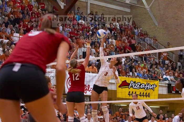 UT junior Lauren Paolini (#3, UTIL) spikes the ball past Nebraska sophomore Rachel Holloway (#12, S) as UT sophomore Ashley Engle (#10, S/RS) and Nebraska senior Sarah Pavan (#9, RS) watch.  The Longhorns defeated the Huskers 3-0 on Wednesday night, Octobe

Filename: SRM_20071024_1914388.jpg
Aperture: f/4.0
Shutter Speed: 1/400
Body: Canon EOS-1D Mark II
Lens: Canon EF 80-200mm f/2.8 L