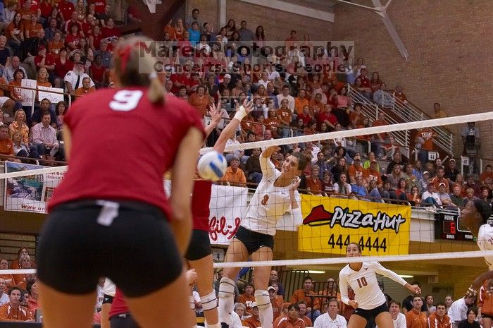 UT junior Lauren Paolini (#3, UTIL) spikes the ball past Nebraska sophomore Rachel Holloway (#12, S) as UT sophomore Ashley Engle (#10, S/RS) and Nebraska senior Sarah Pavan (#9, RS) watch.  The Longhorns defeated the Huskers 3-0 on Wednesday night, Octobe

Filename: SRM_20071024_1914409.jpg
Aperture: f/4.0
Shutter Speed: 1/400
Body: Canon EOS-1D Mark II
Lens: Canon EF 80-200mm f/2.8 L