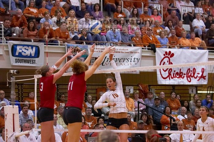 UT sophomore Ashley Engle (#10, S/RS) hits the ball past blockers Nebraska senior Christina Houghtelling (#3, OH) and Nebraska senior Tracy Stalls (#11, MB).  The Longhorns defeated the Huskers 3-0 on Wednesday night, October 24, 2007 at Gregory Gym.

Filename: SRM_20071024_1928502.jpg
Aperture: f/4.0
Shutter Speed: 1/400
Body: Canon EOS-1D Mark II
Lens: Canon EF 80-200mm f/2.8 L