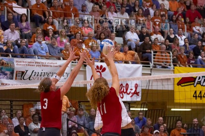 UT sophomore Ashley Engle (#10, S/RS) hits the ball as Nebraska senior Christina Houghtelling (#3, OH) and Nebraska senior Tracy Stalls (#11, MB) attempt to block.  The Longhorns defeated the Huskers 3-0 on Wednesday night, October 24, 2007 at Gregory Gym.

Filename: SRM_20071024_1929223.jpg
Aperture: f/4.0
Shutter Speed: 1/400
Body: Canon EOS-1D Mark II
Lens: Canon EF 80-200mm f/2.8 L