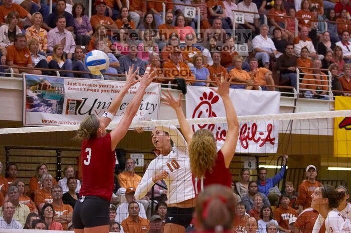 UT sophomore Ashley Engle (#10, S/RS) hits the ball past blockers Nebraska senior Christina Houghtelling (#3, OH) and Nebraska senior Tracy Stalls (#11, MB).  The Longhorns defeated the Huskers 3-0 on Wednesday night, October 24, 2007 at Gregory Gym.

Filename: SRM_20071024_1932083.jpg
Aperture: f/4.0
Shutter Speed: 1/400
Body: Canon EOS-1D Mark II
Lens: Canon EF 80-200mm f/2.8 L