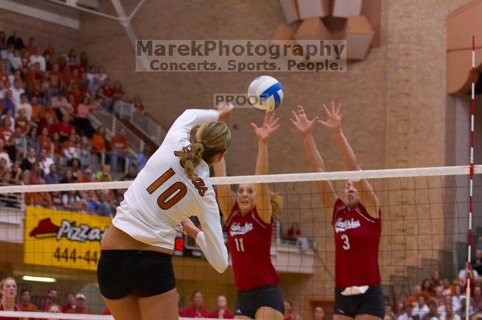 UT sophomore Ashley Engle (#10, S/RS) spikes the ball past Nebraska senior Tracy Stalls (#11, MB) and Nebraska senior Christina Houghtelling (#3, OH).  The Longhorns defeated the Huskers 3-0 on Wednesday night, October 24, 2007 at Gregory Gym.

Filename: SRM_20071024_1957545.jpg
Aperture: f/4.0
Shutter Speed: 1/400
Body: Canon EOS-1D Mark II
Lens: Canon EF 80-200mm f/2.8 L