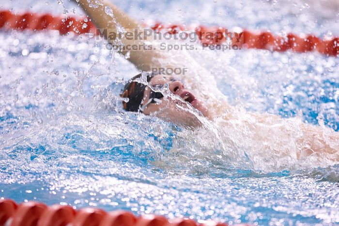 UT sophomore Alan Maher competed in the second heat of the 100 yard backstroke with a time of 51.88.  The University of Texas Longhorns defeated The University of Georgia Bulldogs 157-135 on Saturday, January 12, 2008.

Filename: SRM_20080112_1121041.jpg
Aperture: f/2.8
Shutter Speed: 1/400
Body: Canon EOS-1D Mark II
Lens: Canon EF 300mm f/2.8 L IS