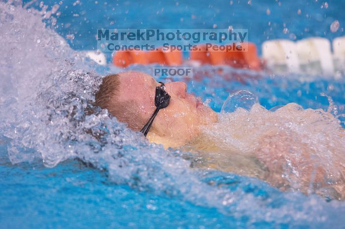 UT senior Matthew McGinnis took first in the 200 yard backstroke with a time of 1:47.37.  The University of Texas Longhorns defeated The University of Georgia Bulldogs 157-135 on Saturday, January 12, 2008.

Filename: SRM_20080112_1158522.jpg
Aperture: f/2.8
Shutter Speed: 1/400
Body: Canon EOS-1D Mark II
Lens: Canon EF 300mm f/2.8 L IS