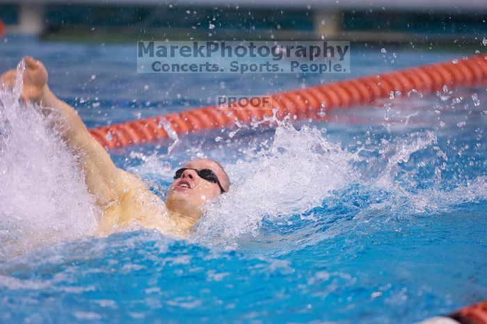 UT senior Matthew McGinnis took first in the 200 yard backstroke with a time of 1:47.37.  The University of Texas Longhorns defeated The University of Georgia Bulldogs 157-135 on Saturday, January 12, 2008.

Filename: SRM_20080112_1159069.jpg
Aperture: f/2.8
Shutter Speed: 1/400
Body: Canon EOS-1D Mark II
Lens: Canon EF 300mm f/2.8 L IS