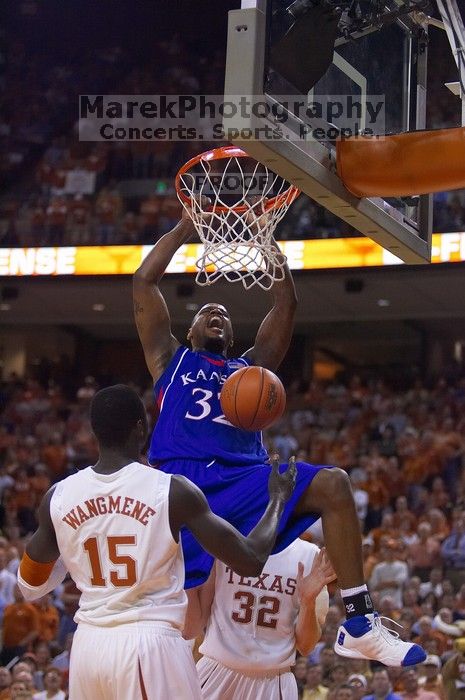 KU senior Darnell Jackson (#32, Forward) dunks over UT freshman Alexis Wangmene (#15, F/C) and UT junior Connor Atchley (#32, F/C).  The University of Texas (UT) Longhorns defeated the University of Kansas Jayhawks 72-69 in Austin, Texas on Monday, February 11, 2008.

Filename: SRM_20080211_2046101.jpg
Aperture: f/2.8
Shutter Speed: 1/640
Body: Canon EOS-1D Mark II
Lens: Canon EF 80-200mm f/2.8 L