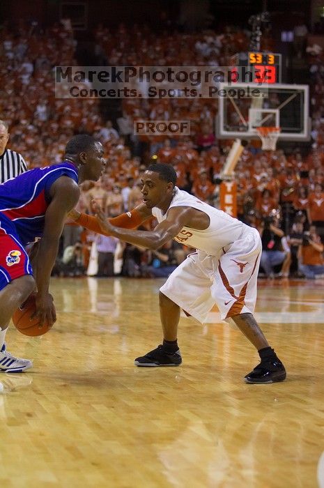 UT junior A.J. Abrams (#3, G) playing defense against a Kansas player.  The University of Texas (UT) Longhorns defeated the University of Kansas Jayhawks 72-69 in Austin, Texas on Monday, February 11, 2008.

Filename: SRM_20080211_2056466.jpg
Aperture: f/2.8
Shutter Speed: 1/640
Body: Canon EOS-1D Mark II
Lens: Canon EF 80-200mm f/2.8 L