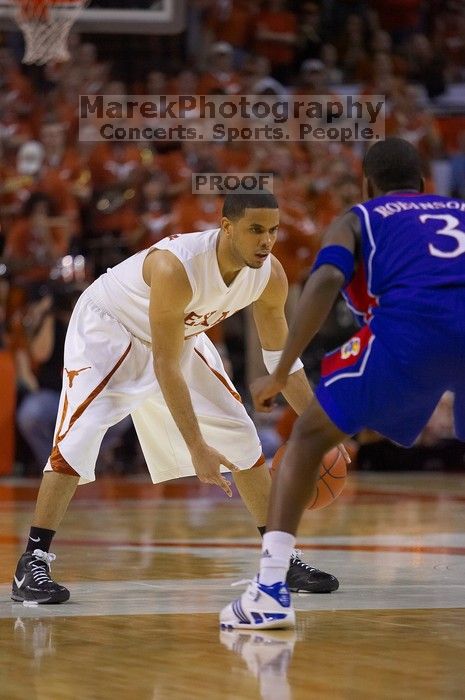 UT junior A.J. Abrams (#3, G) playing defense against a Kansas player.  The University of Texas (UT) Longhorns defeated the University of Kansas Jayhawks 72-69 in Austin, Texas on Monday, February 11, 2008.

Filename: SRM_20080211_2206168.jpg
Aperture: f/2.8
Shutter Speed: 1/640
Body: Canon EOS-1D Mark II
Lens: Canon EF 80-200mm f/2.8 L