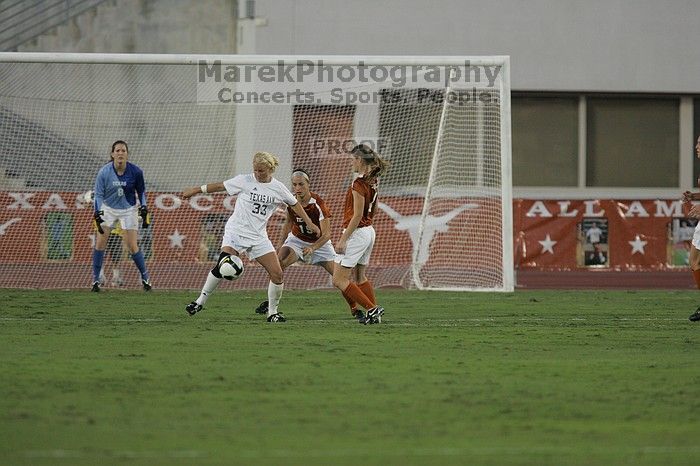 UT sophomore Erica Campanelli (#19, Defender) and UT senior Jill Gilbeau (#4, Defender and Midfielder) defend as UT senior Dianna Pfenninger (#8, Goalkeeper) watches.  The University of Texas women's soccer team tied 0-0 against the Texas A&M Aggies Friday night, September 27, 2008.

Filename: SRM_20080926_1924006.jpg
Aperture: f/4.0
Shutter Speed: 1/500
Body: Canon EOS-1D Mark II
Lens: Canon EF 300mm f/2.8 L IS