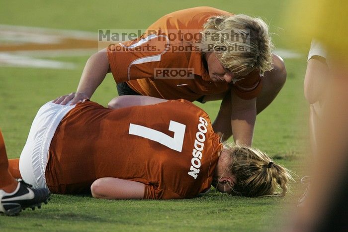 UT freshman Courtney Goodson (#7, Forward and Midfielder) lies on the field injured as her coach checks on her.  The University of Texas women's soccer team tied 0-0 against the Texas A&M Aggies Friday night, September 27, 2008.

Filename: SRM_20080926_1925080.jpg
Aperture: f/4.0
Shutter Speed: 1/200
Body: Canon EOS-1D Mark II
Lens: Canon EF 300mm f/2.8 L IS