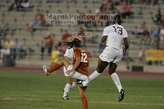 UT sophomore Alisha Ortiz (#12, Forward) gets kicked in the butt by A&M #13.  The University of Texas women's soccer team tied 0-0 against the Texas A&M Aggies Friday night, September 27, 2008.

Filename: SRM_20080926_1929123.jpg
Aperture: f/4.0
Shutter Speed: 1/400
Body: Canon EOS-1D Mark II
Lens: Canon EF 300mm f/2.8 L IS