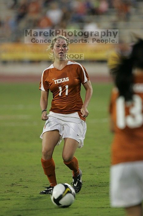 UT sophomore Niki Arlitt (#11, Forward) passes the ball to UT freshman Amanda Lisberger (#13, Midfielder).   The University of Texas women's soccer team tied 0-0 against the Texas A&M Aggies Friday night, September 27, 2008.

Filename: SRM_20080926_1929405.jpg
Aperture: f/4.0
Shutter Speed: 1/320
Body: Canon EOS-1D Mark II
Lens: Canon EF 300mm f/2.8 L IS