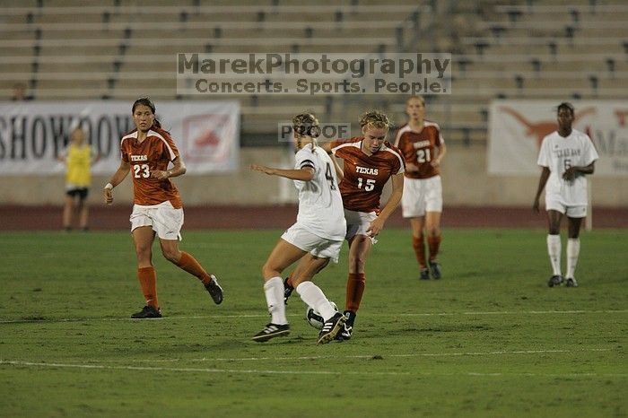 UT freshman Kylie Doniak (#15, Midfielder) takes the ball downfield as UT junior Emily Anderson (#21, Forward) and UT senior Courtney Gaines (#23, Midfielder) watch.  The University of Texas women's soccer team tied 0-0 against the Texas A&M Aggies Friday night, September 27, 2008.

Filename: SRM_20080926_1935066.jpg
Aperture: f/4.0
Shutter Speed: 1/500
Body: Canon EOS-1D Mark II
Lens: Canon EF 300mm f/2.8 L IS