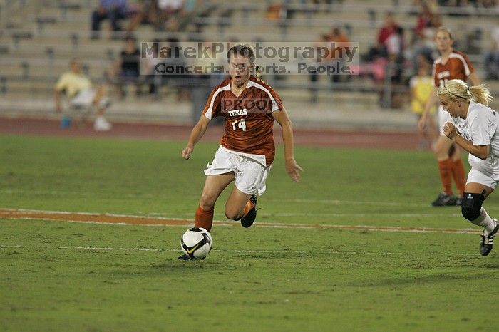 UT senior Kasey Moore (#14, Defender) brings the ball downfield.  The University of Texas women's soccer team tied 0-0 against the Texas A&M Aggies Friday night, September 27, 2008.

Filename: SRM_20080926_1935342.jpg
Aperture: f/4.0
Shutter Speed: 1/400
Body: Canon EOS-1D Mark II
Lens: Canon EF 300mm f/2.8 L IS