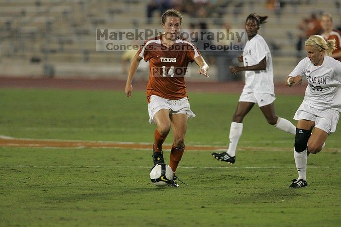 UT senior Kasey Moore (#14, Defender) brings the ball downfield.  The University of Texas women's soccer team tied 0-0 against the Texas A&M Aggies Friday night, September 27, 2008.

Filename: SRM_20080926_1935387.jpg
Aperture: f/4.0
Shutter Speed: 1/500
Body: Canon EOS-1D Mark II
Lens: Canon EF 300mm f/2.8 L IS