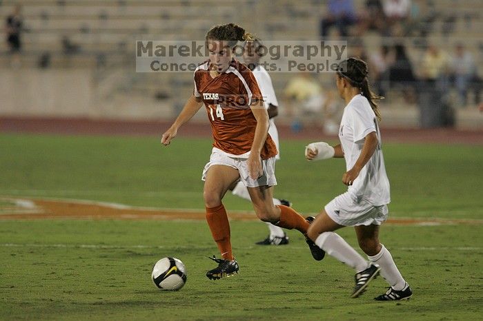 UT senior Kasey Moore (#14, Defender) brings the ball downfield.  The University of Texas women's soccer team tied 0-0 against the Texas A&M Aggies Friday night, September 27, 2008.

Filename: SRM_20080926_1935401.jpg
Aperture: f/4.0
Shutter Speed: 1/400
Body: Canon EOS-1D Mark II
Lens: Canon EF 300mm f/2.8 L IS