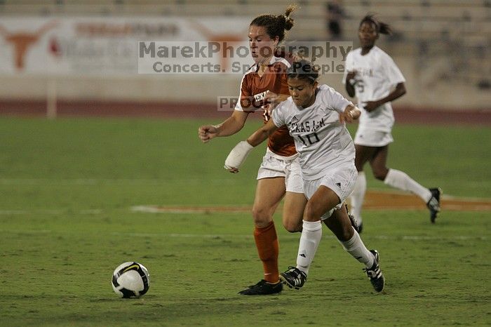 UT senior Kasey Moore (#14, Defender) brings the ball downfield.  The University of Texas women's soccer team tied 0-0 against the Texas A&M Aggies Friday night, September 27, 2008.

Filename: SRM_20080926_1935425.jpg
Aperture: f/4.0
Shutter Speed: 1/500
Body: Canon EOS-1D Mark II
Lens: Canon EF 300mm f/2.8 L IS