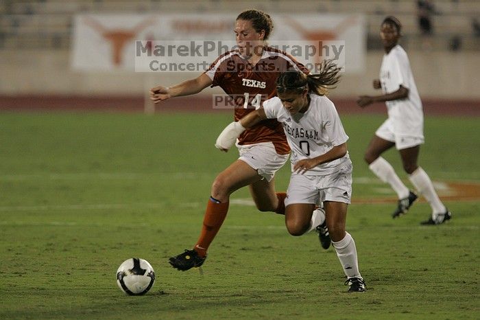 UT senior Kasey Moore (#14, Defender) brings the ball downfield.  The University of Texas women's soccer team tied 0-0 against the Texas A&M Aggies Friday night, September 27, 2008.

Filename: SRM_20080926_1935426.jpg
Aperture: f/4.0
Shutter Speed: 1/500
Body: Canon EOS-1D Mark II
Lens: Canon EF 300mm f/2.8 L IS