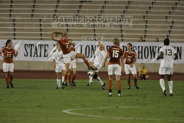 UT freshman Lucy Keith (#6, Midfielder) settles the ball as UT senior Stephanie Logterman (#10, Defender), UT freshman Kylie Doniak (#15, Midfielder), UT senior Courtney Gaines (#23, Midfielder) watch.  The University of Texas women's soccer team tied 0-0 against the Texas A&M Aggies Friday night, September 27, 2008.

Filename: SRM_20080926_1940028.jpg
Aperture: f/4.0
Shutter Speed: 1/500
Body: Canon EOS-1D Mark II
Lens: Canon EF 300mm f/2.8 L IS