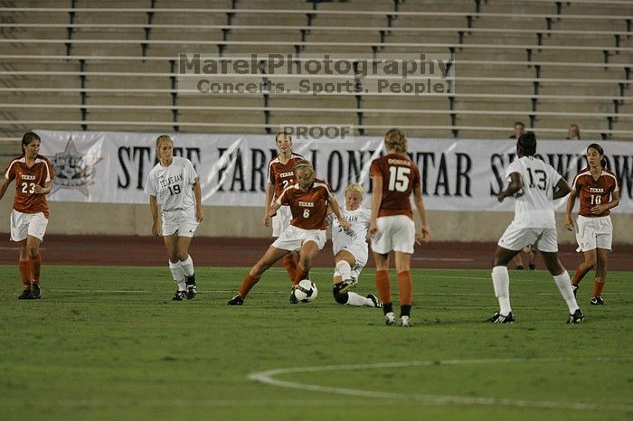 UT freshman Lucy Keith (#6, Midfielder) settles the ball as UT senior Stephanie Logterman (#10, Defender), UT freshman Kylie Doniak (#15, Midfielder), UT senior Courtney Gaines (#23, Midfielder) watch.  The University of Texas women's soccer team tied 0-0 against the Texas A&M Aggies Friday night, September 27, 2008.

Filename: SRM_20080926_1940041.jpg
Aperture: f/4.0
Shutter Speed: 1/500
Body: Canon EOS-1D Mark II
Lens: Canon EF 300mm f/2.8 L IS