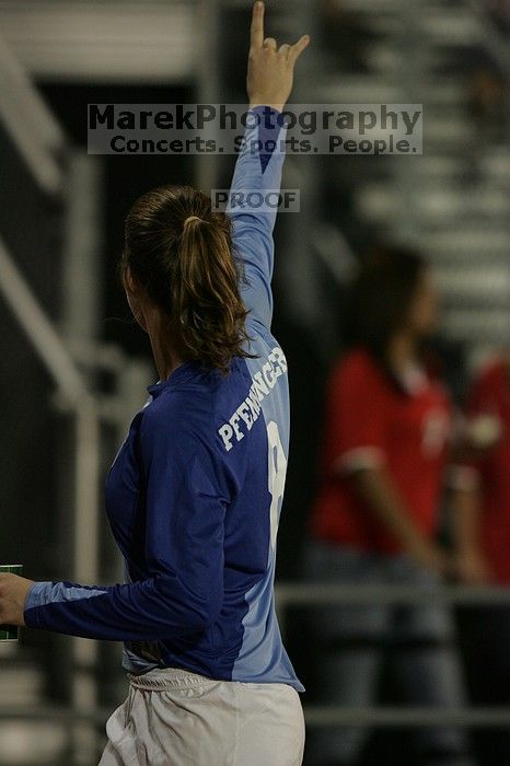 UT senior Dianna Pfenninger (#8, Goalkeeper) gives a Hook'em to the fans as they leave the field at the end of the first half.  The University of Texas women's soccer team tied 0-0 against the Texas A&M Aggies Friday night, September 27, 2008.

Filename: SRM_20080926_1948165.jpg
Aperture: f/2.8
Shutter Speed: 1/500
Body: Canon EOS-1D Mark II
Lens: Canon EF 300mm f/2.8 L IS