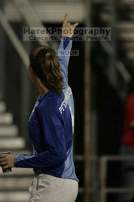 UT senior Dianna Pfenninger (#8, Goalkeeper) gives a Hook'em to the fans as they leave the field at the end of the first half.  The University of Texas women's soccer team tied 0-0 against the Texas A&M Aggies Friday night, September 27, 2008.

Filename: SRM_20080926_1948166.jpg
Aperture: f/2.8
Shutter Speed: 1/500
Body: Canon EOS-1D Mark II
Lens: Canon EF 300mm f/2.8 L IS