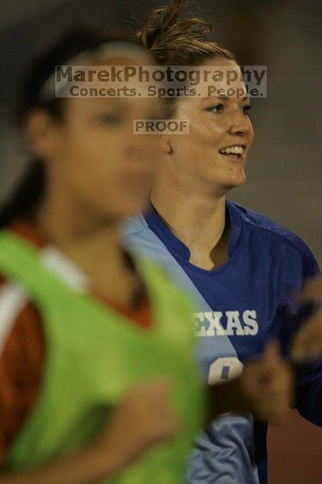 UT senior Dianna Pfenninger (#8, Goalkeeper) running back to the team benches before the second half.  The University of Texas women's soccer team tied 0-0 against the Texas A&M Aggies Friday night, September 27, 2008.

Filename: SRM_20080926_2000503.jpg
Aperture: f/2.8
Shutter Speed: 1/500
Body: Canon EOS-1D Mark II
Lens: Canon EF 300mm f/2.8 L IS