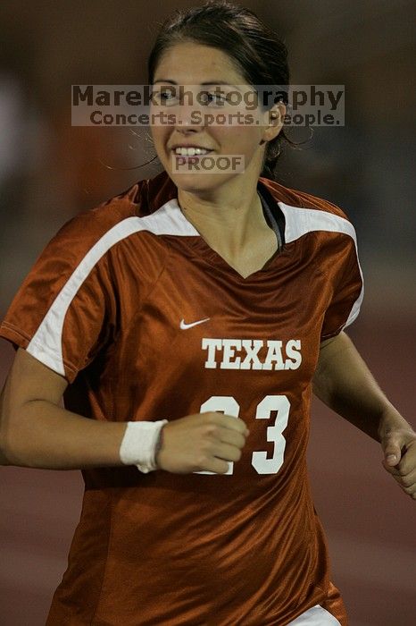 UT senior Courtney Gaines (#23, Midfielder) running back to the team benches before the second half.  The University of Texas women's soccer team tied 0-0 against the Texas A&M Aggies Friday night, September 27, 2008.

Filename: SRM_20080926_2000560.jpg
Aperture: f/2.8
Shutter Speed: 1/500
Body: Canon EOS-1D Mark II
Lens: Canon EF 300mm f/2.8 L IS