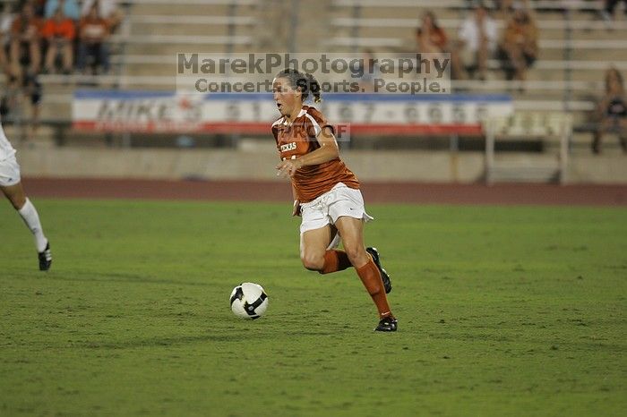 UT senior Kasey Moore (#14, Defender).  The University of Texas women's soccer team tied 0-0 against the Texas A&M Aggies Friday night, September 27, 2008.

Filename: SRM_20080926_2012102.jpg
Aperture: f/2.8
Shutter Speed: 1/500
Body: Canon EOS-1D Mark II
Lens: Canon EF 300mm f/2.8 L IS