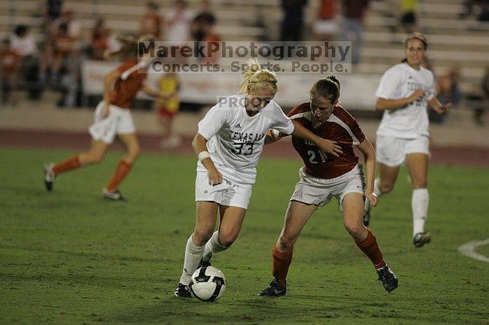 UT junior Emily Anderson (#21, Forward) plays defense on A&M #33.  The University of Texas women's soccer team tied 0-0 against the Texas A&M Aggies Friday night, September 27, 2008.

Filename: SRM_20080926_2027400.jpg
Aperture: f/2.8
Shutter Speed: 1/640
Body: Canon EOS-1D Mark II
Lens: Canon EF 300mm f/2.8 L IS