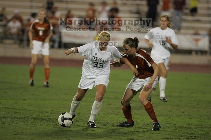 UT junior Emily Anderson (#21, Forward) plays defense on A&M #33.  The University of Texas women's soccer team tied 0-0 against the Texas A&M Aggies Friday night, September 27, 2008.

Filename: SRM_20080926_2027408.jpg
Aperture: f/2.8
Shutter Speed: 1/640
Body: Canon EOS-1D Mark II
Lens: Canon EF 300mm f/2.8 L IS