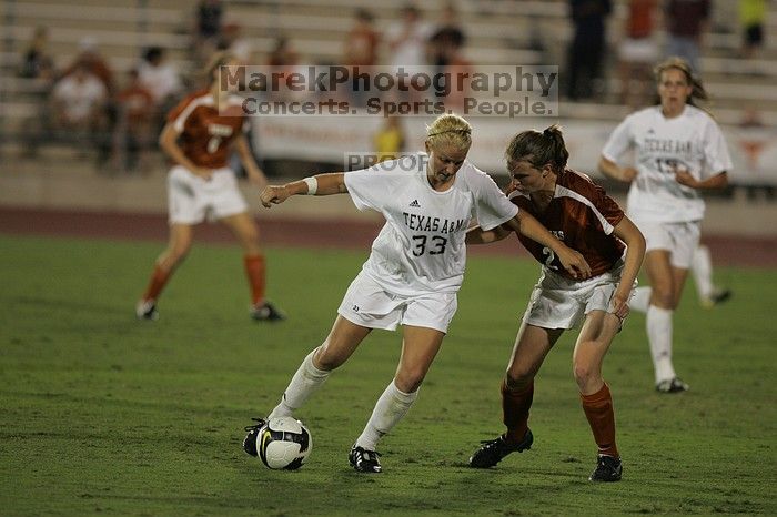 UT junior Emily Anderson (#21, Forward) plays defense on A&M #33.  The University of Texas women's soccer team tied 0-0 against the Texas A&M Aggies Friday night, September 27, 2008.

Filename: SRM_20080926_2027409.jpg
Aperture: f/2.8
Shutter Speed: 1/640
Body: Canon EOS-1D Mark II
Lens: Canon EF 300mm f/2.8 L IS