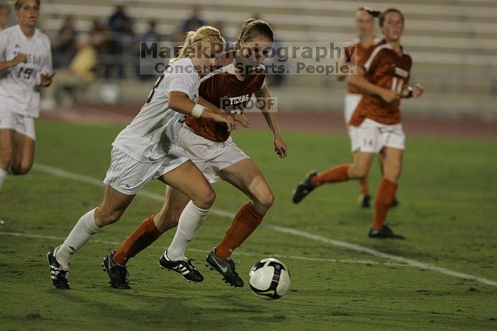 UT junior Emily Anderson (#21, Forward) plays defense on A&M #33.  The University of Texas women's soccer team tied 0-0 against the Texas A&M Aggies Friday night, September 27, 2008.

Filename: SRM_20080926_2027425.jpg
Aperture: f/2.8
Shutter Speed: 1/640
Body: Canon EOS-1D Mark II
Lens: Canon EF 300mm f/2.8 L IS