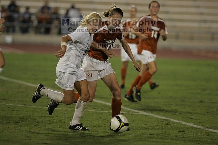 UT junior Emily Anderson (#21, Forward) plays defense on A&M #33.  The University of Texas women's soccer team tied 0-0 against the Texas A&M Aggies Friday night, September 27, 2008.

Filename: SRM_20080926_2027446.jpg
Aperture: f/2.8
Shutter Speed: 1/640
Body: Canon EOS-1D Mark II
Lens: Canon EF 300mm f/2.8 L IS