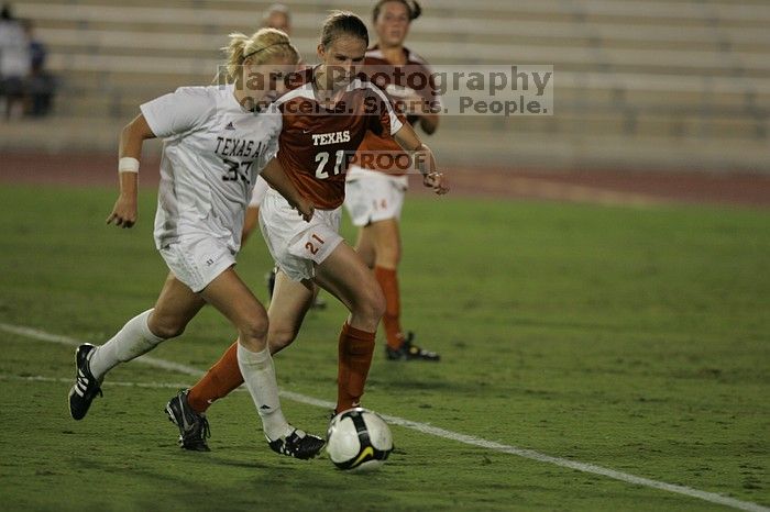 UT junior Emily Anderson (#21, Forward) plays defense on A&M #33.  The University of Texas women's soccer team tied 0-0 against the Texas A&M Aggies Friday night, September 27, 2008.

Filename: SRM_20080926_2027447.jpg
Aperture: f/2.8
Shutter Speed: 1/640
Body: Canon EOS-1D Mark II
Lens: Canon EF 300mm f/2.8 L IS