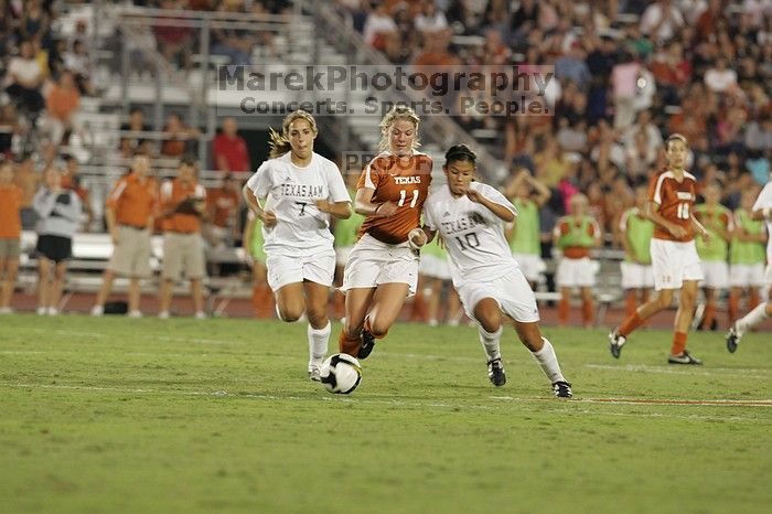 UT sophomore Niki Arlitt (#11, Forward) battles for the ball.  The University of Texas women's soccer team tied 0-0 against the Texas A&M Aggies Friday night, September 27, 2008.

Filename: SRM_20080926_2036546.jpg
Aperture: f/4.0
Shutter Speed: 1/200
Body: Canon EOS-1D Mark II
Lens: Canon EF 300mm f/2.8 L IS