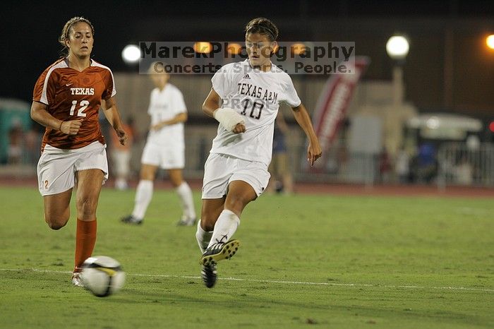 UT sophomore Alisha Ortiz (#12, Forward) takes the ball down the field.  The University of Texas women's soccer team tied 0-0 against the Texas A&M Aggies Friday night, September 27, 2008.

Filename: SRM_20080926_2041184.jpg
Aperture: f/4.0
Shutter Speed: 1/200
Body: Canon EOS-1D Mark II
Lens: Canon EF 300mm f/2.8 L IS