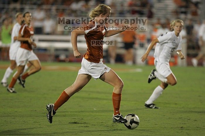 UT freshman Courtney Goodson (#7, Forward and Midfielder) takes the ball down the field.  The University of Texas women's soccer team tied 0-0 against the Texas A&M Aggies Friday night, September 27, 2008.

Filename: SRM_20080926_2048301.jpg
Aperture: f/2.8
Shutter Speed: 1/500
Body: Canon EOS-1D Mark II
Lens: Canon EF 300mm f/2.8 L IS