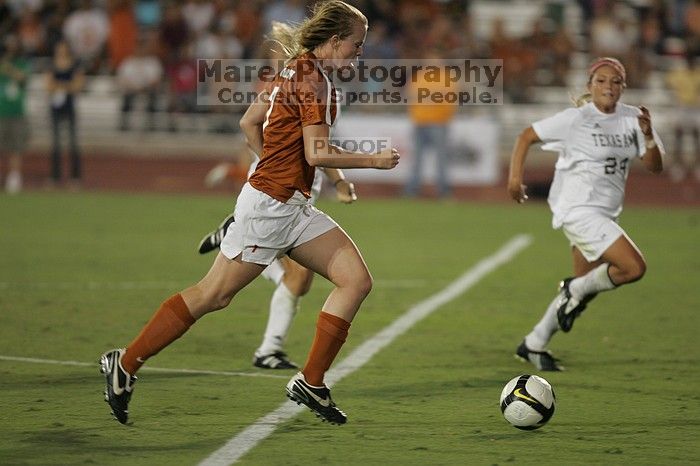 UT freshman Courtney Goodson (#7, Forward and Midfielder) takes the ball down the field.  The University of Texas women's soccer team tied 0-0 against the Texas A&M Aggies Friday night, September 27, 2008.

Filename: SRM_20080926_2048324.jpg
Aperture: f/2.8
Shutter Speed: 1/500
Body: Canon EOS-1D Mark II
Lens: Canon EF 300mm f/2.8 L IS