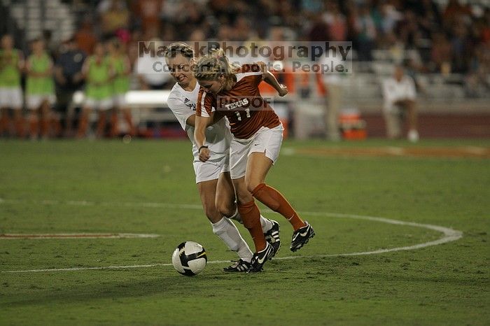 UT sophomore Niki Arlitt (#11, Forward) steals the ball from an Aggie.  The University of Texas women's soccer team tied 0-0 against the Texas A&M Aggies Friday night, September 27, 2008.

Filename: SRM_20080926_2056085.jpg
Aperture: f/2.8
Shutter Speed: 1/640
Body: Canon EOS-1D Mark II
Lens: Canon EF 300mm f/2.8 L IS