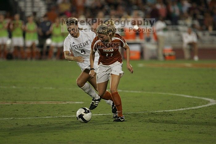 UT sophomore Niki Arlitt (#11, Forward) steals the ball from an Aggie.  The University of Texas women's soccer team tied 0-0 against the Texas A&M Aggies Friday night, September 27, 2008.

Filename: SRM_20080926_2056086.jpg
Aperture: f/2.8
Shutter Speed: 1/640
Body: Canon EOS-1D Mark II
Lens: Canon EF 300mm f/2.8 L IS